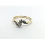 An 18carat gold ring set with a diamond flanked by