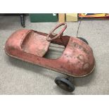 An unusual vintage three wheel pedal car