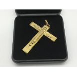 A cased yellow metal crucifix.