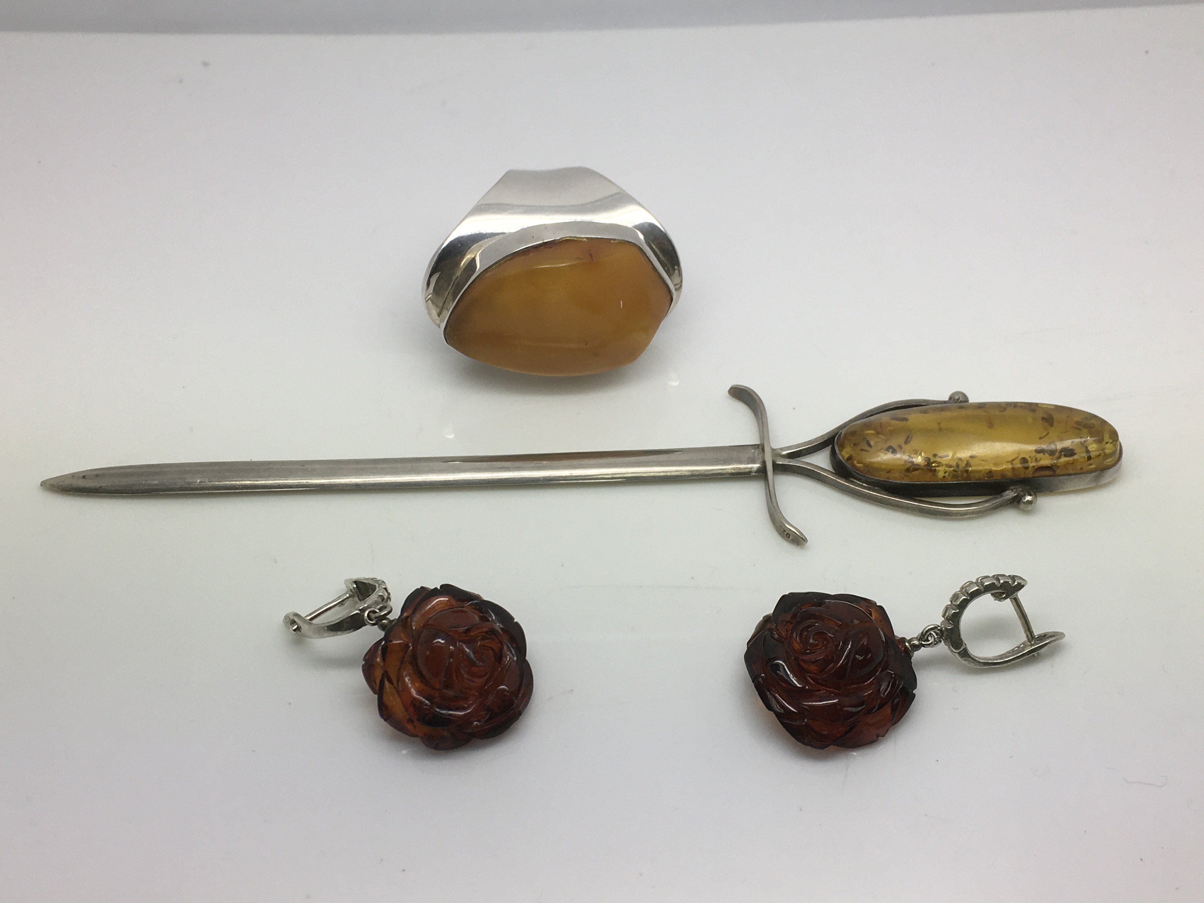Silver and amber items comprising a pair of earrin