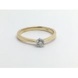 An 18ct gold solitaire diamond ring, approx .10ct, approx 2.5g and approx size N.