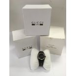 A boxed Gucci Sync designer watch, seen working.