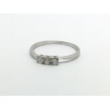 A platinum and three stone diamond ring marked 950