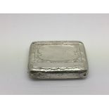 A small silver powder box with chased decoration,