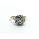 An 18 carat gold ring set with a cluster of diamonds ring size M.