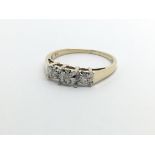 A 9ct gold three stone diamond ring, approx .10ct,