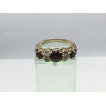 A 9ct gold ring set with garnets, approx 3.2g and