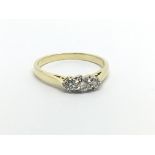 An 18ct gold three stone diamond ring, approx .25ct, approx 2.6g and approx size M-N.