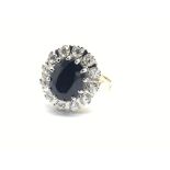A 9ct gold ring set with a central sapphire surrounded by diamonds, approx.60ct, approx 5.4g and