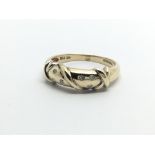 A 9ct gold ring set with six small diamonds, appro