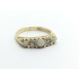 An 18ct gold ring set with three opals and two diamonds, approx 3.7g and approx size M.