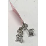 A pair of 14ct White gold and princess cut Stud Ea