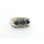 A 9carat gold ring set with three sapphire and chip stone diamonds ring size J.