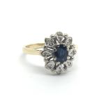 An 18ct gold eing set with a central sapphire and eight small diamonds, approx 3.5g and approx