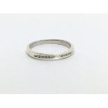 A 9ct white gold ring set with ten small diamonds,