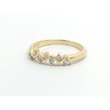 An 18ct gold ring set with seven small diamonds, approx .10ct, approx 2.5g and approx size K-L.