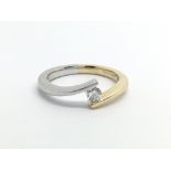 An 18ct white and yellow gold solitaire diamond ring, approx .20ct, approx 2.7g and approx size M.