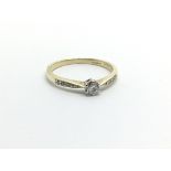 A 9ct gold solitaire diamond ring with further diamonds to the shoulders, approx 1.7g and approx