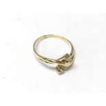 An 18ct gold and 2 diamond crossover ring (unmarked but tested).