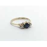 A 9ct gold eing set with a central sapphire and a diamond either side, approx 1.3g and approx size