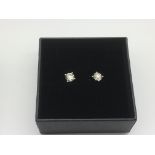 A boxed pair of 18ct white gold solitaire diamond