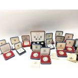 A collection of seventeen cased silver proof coins