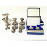A collection of small silver candle sticks and vas