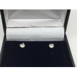 A boxed pair of 18ct white gold diamond ear studs,