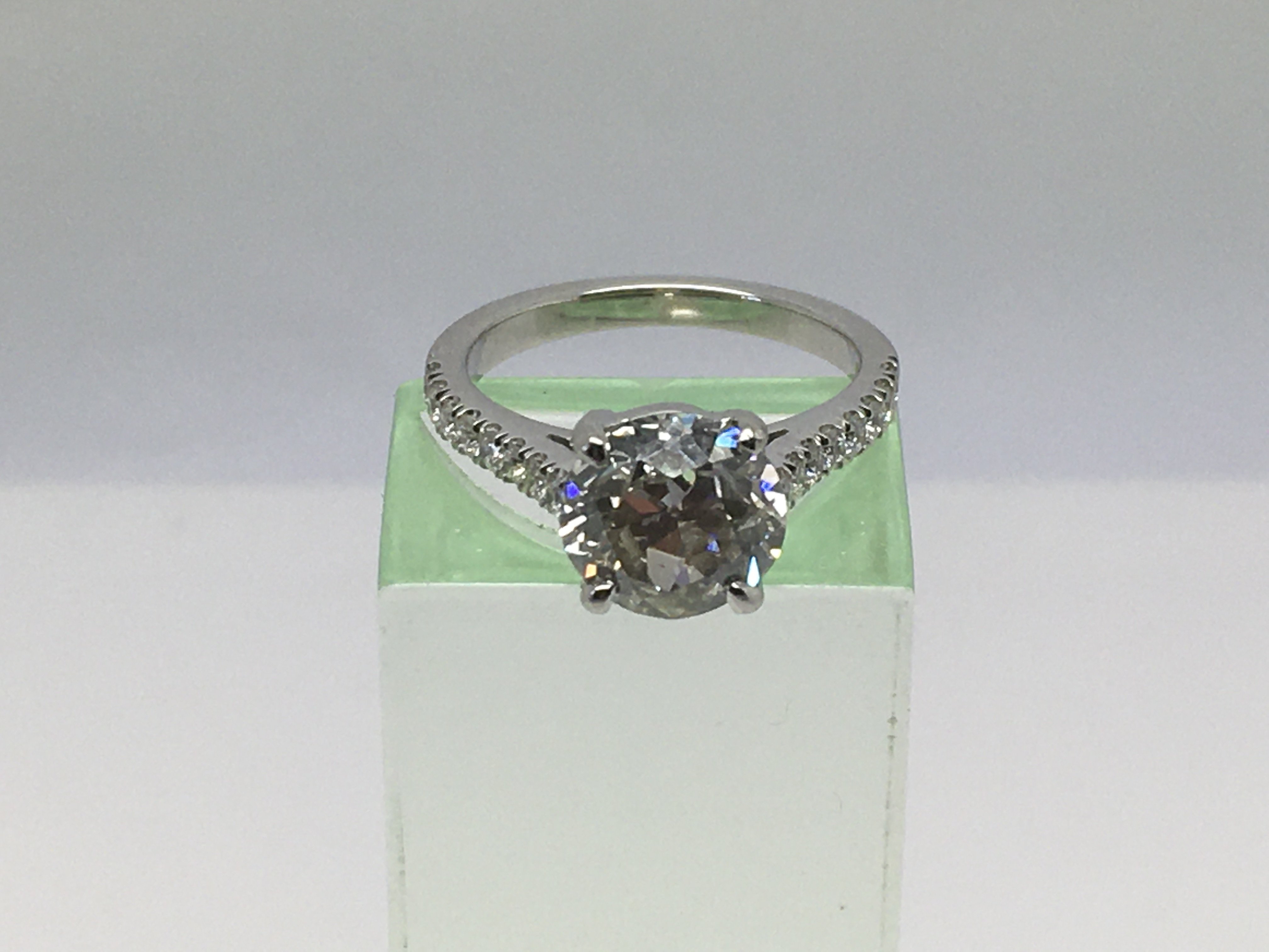 A platinum solitaire diamond ring, the central sto