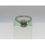 A platinum solitaire diamond ring, the central sto