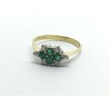 An 18ct gold diamond and emerald ring, approx 2g a