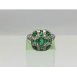 An Art Deco style platinum ring set with emeralds