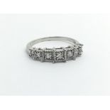 An 18ct white gold seven stone diamond ring, approx 2.8g and approx size M-N.