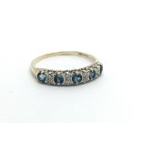 A 9ct gold ring set with diamonds and topaz, appro