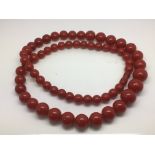 A vintage phenolic red bead graduated necklace.