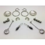 Six pairs of silver earrings, mostly set with ston