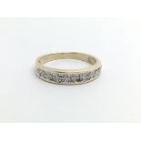 An unmarked gold half eternity ring, approx 1.8g and approx size M.