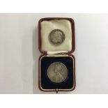 A cased silver George V coronation medal plus a 18