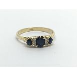 An 18carat gold ring set with three sapphire and small diamonds ring size P-Q