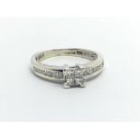 A 9ct white gold and .33ct illusion set diamond diamond ring. (I/J)