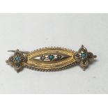 A Edwardian 9 ct brooch inset with turquoise and seed pearl stones .