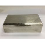 Withdrawn -A heavy silver cigarette box with engine turned de