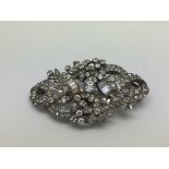 An antique silver and paste double clip brooch.