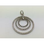 A silver and stone set modern pendant of circular