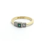 An 18ct gold ring set with a central emerald and a diamond either side, approx 3.2g and approx