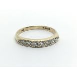 A 9ct gold half eternity ring set with seven diamonds, approx .20ct, approx 1.8g and approx size K.