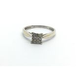 A 9ct white gold ring set with nine diamonds, approx .12ct, approx 1.5g and approx size O.