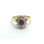 An 18ct gold eing set with a central ruby surrounded by diamonds, approx 3g and approx size H-I.
