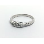 An 18ct white gold three stone diamond ring, appro