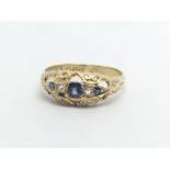 A Vintage gold ring set with blue sapphire and chip stone diamonds ring size O-P